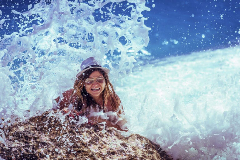 Girl in the ocean lauging at mermaid puns