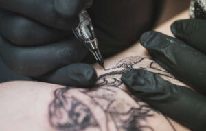 A mermaid skeleton tattoo is being made on the skin